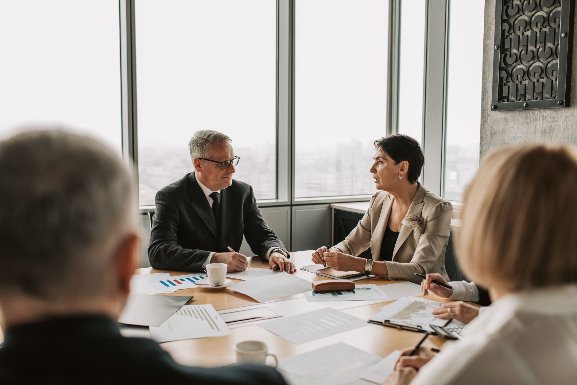 Senior executives reviewing operational and financial charts in a strategy meeting