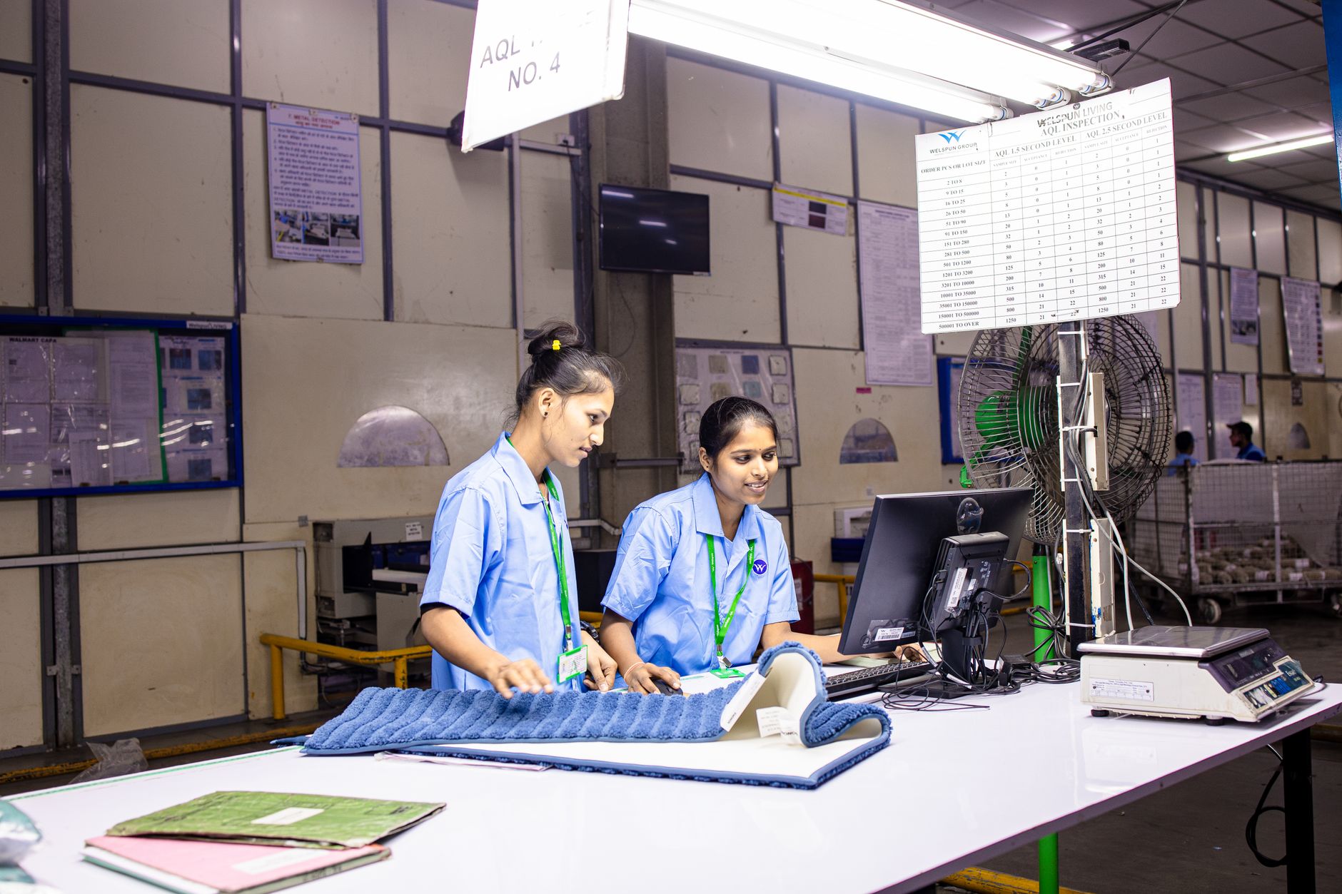 Workers inspecting products at a factory quality-control station